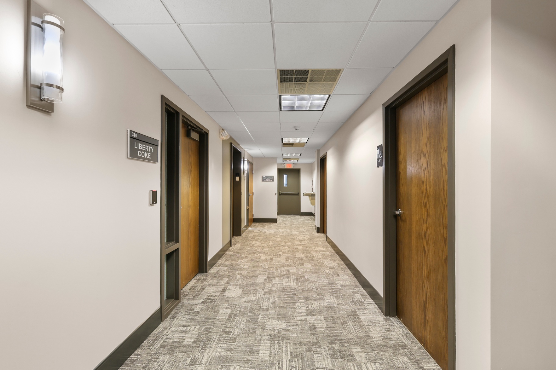 Tenant corridor with new carpet, signage, and updated lighting