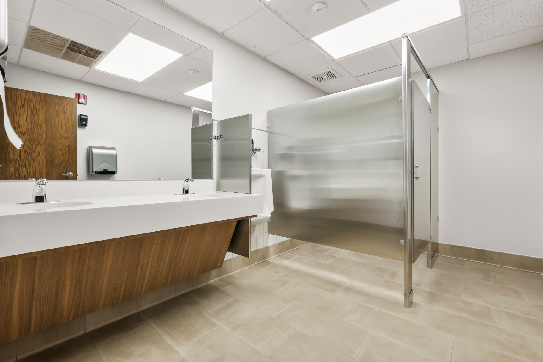 Restroom renovation with floating vanity and stainless partitions