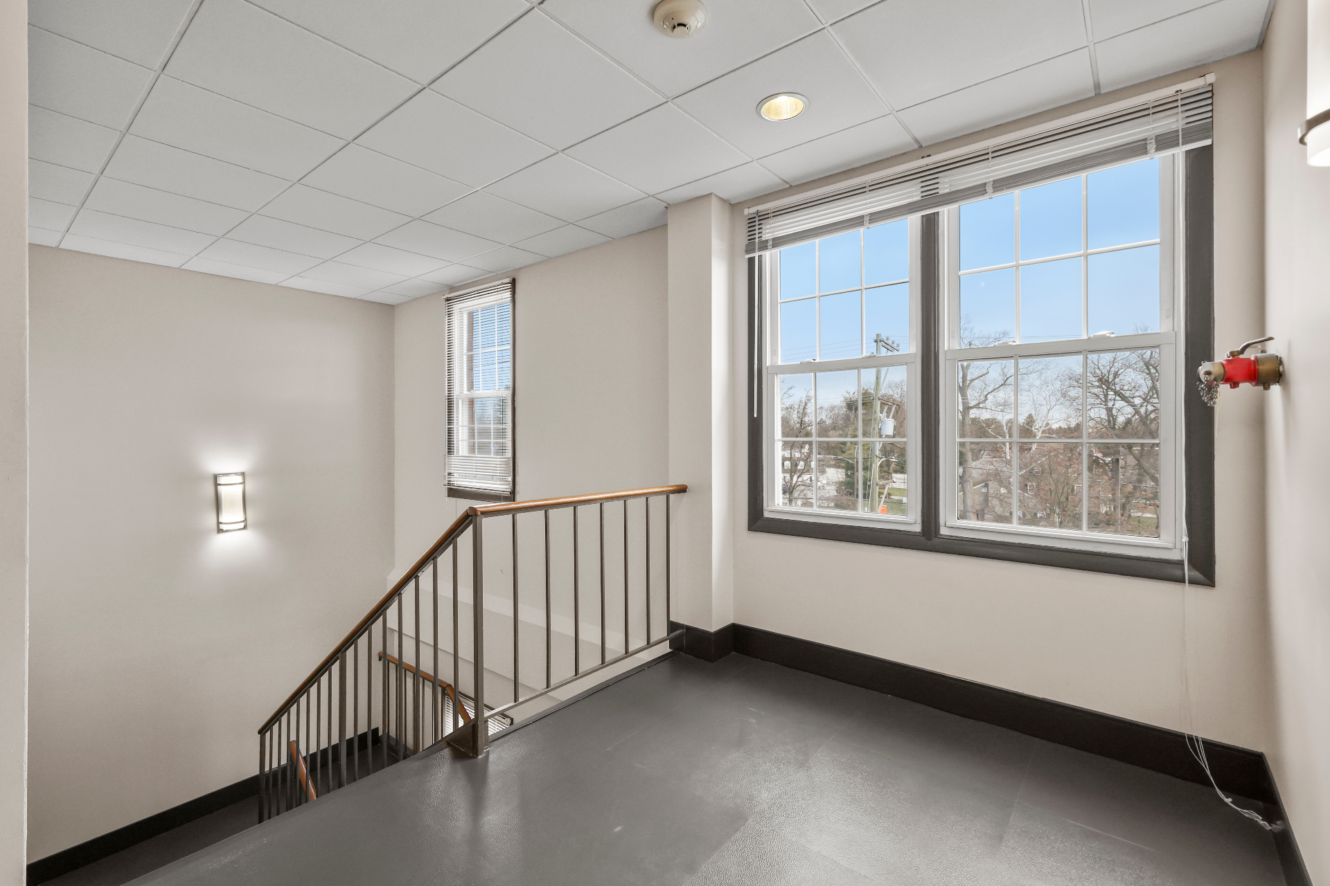 Upper stair landing with fresh paint, lighting, and window trim