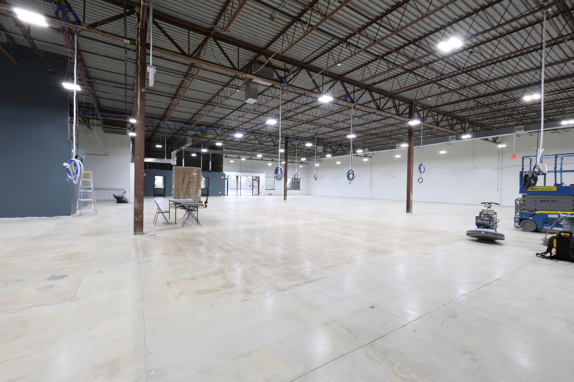 Interior view toward entry vestibule with fresh paint and prepped concrete